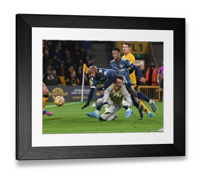 Framed Print : Arsenal's Lacazette Faces Off Against Wolverhampton's Sa in Premier League Clash