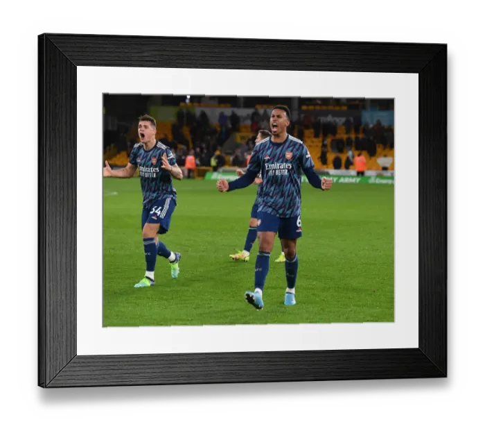 Framed Print : Granit Xhaka and Gabriel's Jubilant Moment: Arsenal's Win Against Wolverhampton Wanderers in the Premier League