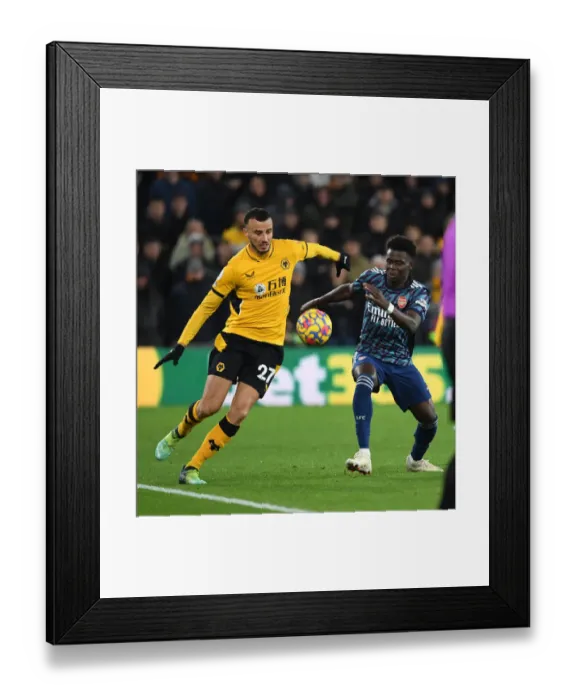 Framed Print : Saka vs. Saiss: Intense Battle in Wolverhampton Wanderers vs. Arsenal Premier League Clash