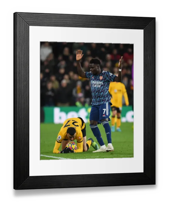 Framed Print : Bukayo Saka vs. Romain Saiss: Intense Battle in Wolverhampton Wanderers vs. Arsenal Premier League Clash