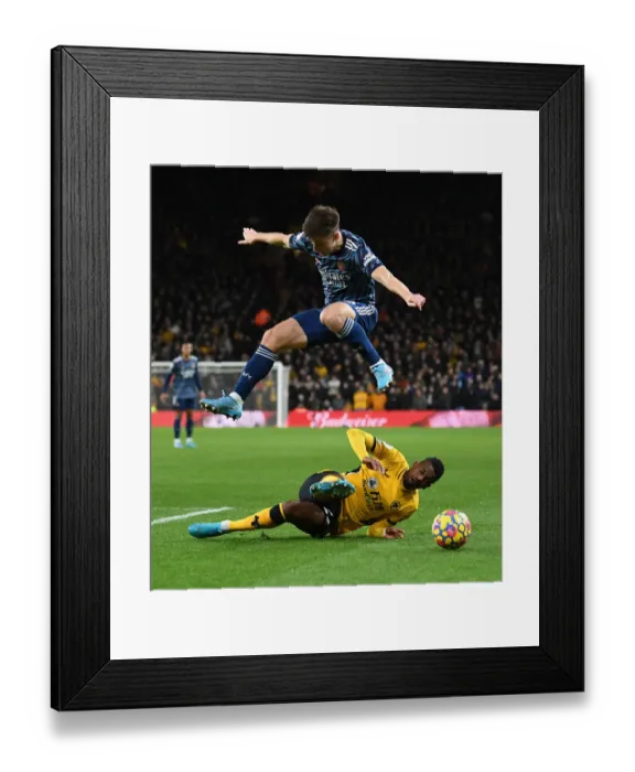 Framed Print : Arsenal's Kieran Tierney Leaps Over Wolves Francisco Trincao in Premier League Clash