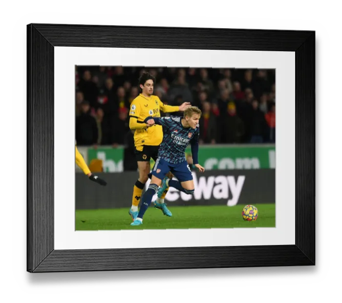 Framed Print : Martin Odegaard vs Francisco Trincao: Intense Battle in Wolverhampton Wanderers vs Arsenal Premier League Clash