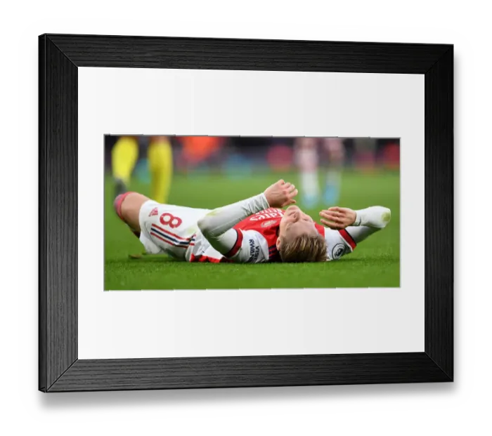 Framed Print : Arsenal's Martin Odegaard Suffers Injury in Arsenal vs. Brentford Clash at Emirates Stadium Framed Print : Arsenal's Martin Odegaard Suffers Injury in Arsenal vs. Brentford Clash at Emirates Stadium
