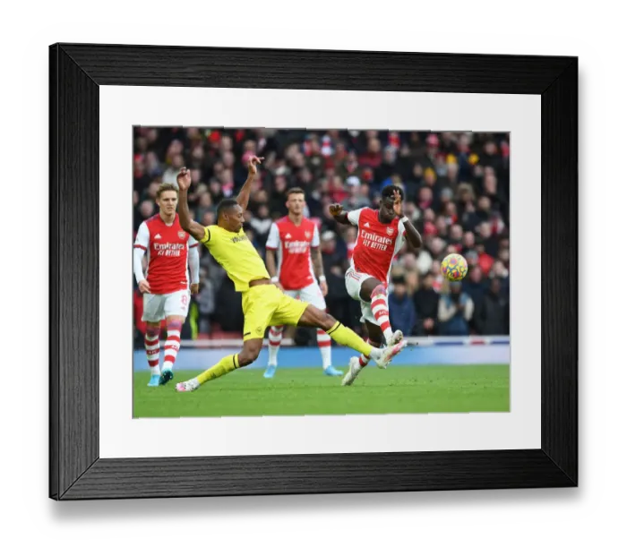 Framed Print : Arsenal's Bukayo Saka vs. Ethan Pinnock: A Premier League Face-Off at Emirates Stadium Framed Print : Arsenal's Bukayo Saka vs. Ethan Pinnock: A Premier League Face-Off at Emirates Stadium