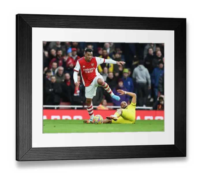 Framed Print : Arsenal's Gabriel Outmuscles Brentford's Mbeumo in Premier League Clash