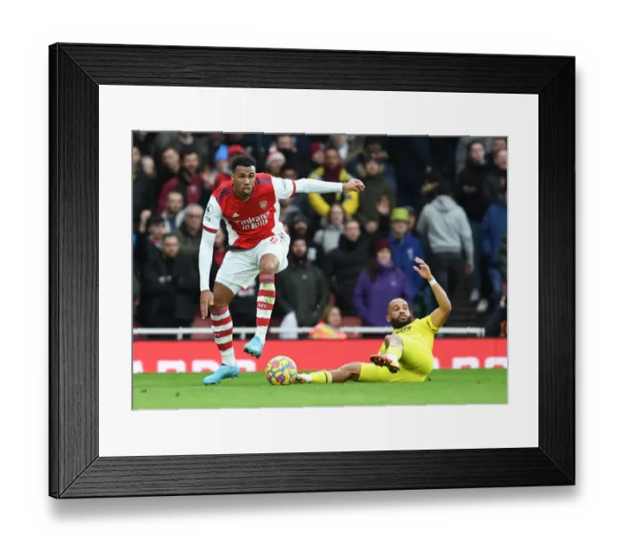 Framed Print : Gabriel Outmaneuvers Mbeumo: Arsenal vs. Brentford in Premier League Action - Arsenal's Gabriel Evades Rival Player
