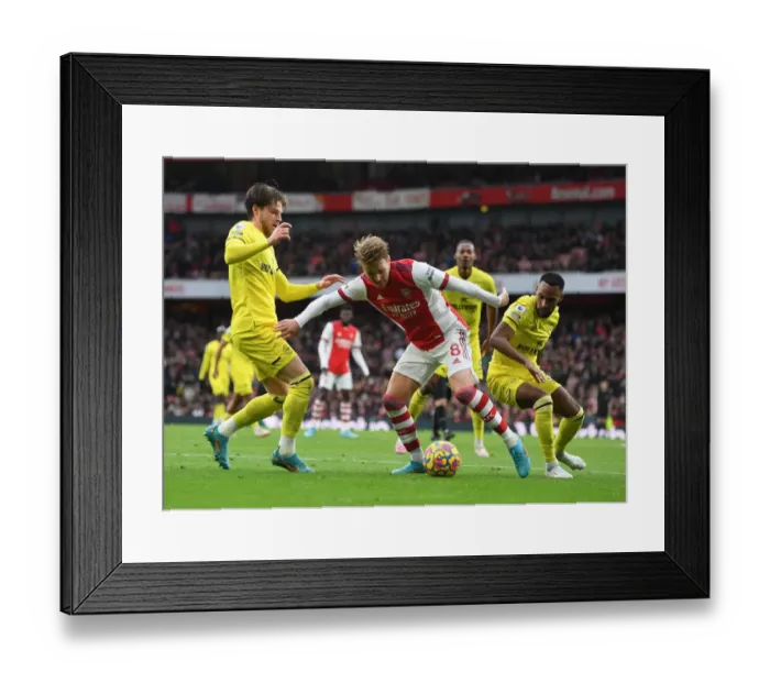 Framed Print : Arsenal's Martin Odegaard Clashes with Brentford's Mathias Jensen and Rico Henry during the Premier League Match Framed Print : Arsenal's Martin Odegaard Clashes with Brentford's Mathias Jensen and Rico Henry during the Premier League Match