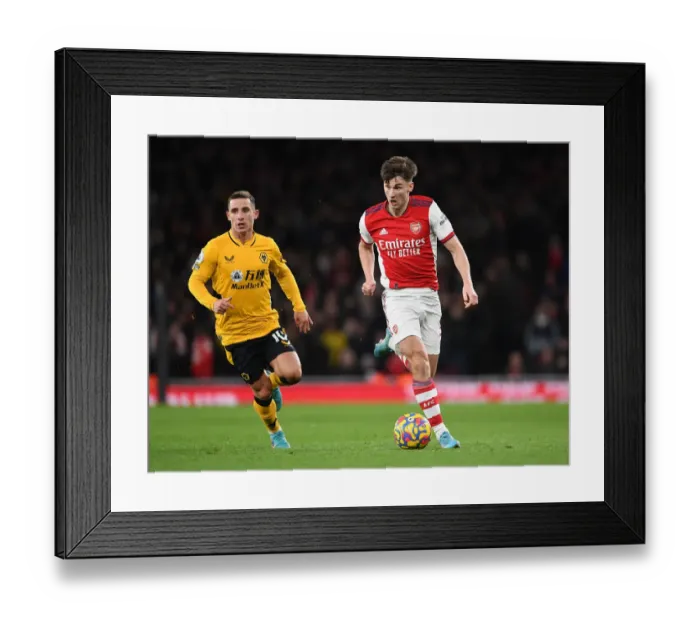 Framed Print : Arsenal's Kieran Tierney Outmaneuvers Wolves Daniel Podence in Premier League Clash
