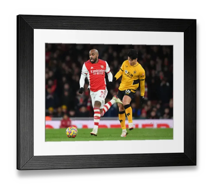 Framed Print : Arsenal's Lacazette Goes Head-to-Head with Wolverhampton's Hwang Hee-Chan: Premier League Clash (2021-22)