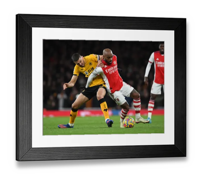 Framed Print : Arsenal vs. Wolverhampton Wanderers: Lacazette vs. Coady - Premier League Showdown: A Battle of Stars at Emirates Stadium