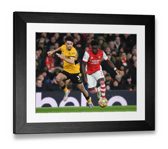 Framed Print : Arsenal's Bukayo Saka Outmaneuvers Wolves Rayan Ait-Nouri in Premier League Clash