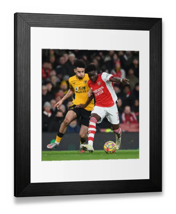 Framed Print : Bukayo Saka's Slick Moves: Outsmarting Wolves Ait-Nouri in Arsenal's Premier League Victory Framed Print : Bukayo Saka's Slick Moves: Outsmarting Wolves Ait-Nouri in Arsenal's Premier League Victory