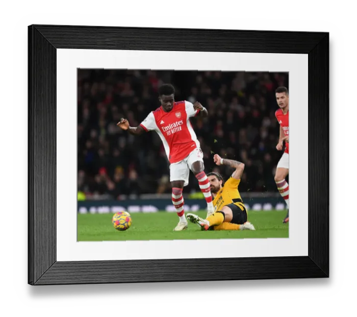 Framed Print : Arsenal's Bukayo Saka Clashes with Wolves Ruben Neves in Premier League Showdown Framed Print : Arsenal's Bukayo Saka Clashes with Wolves Ruben Neves in Premier League Showdown