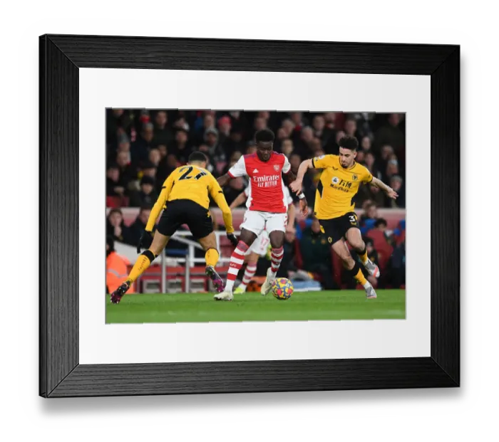 Framed Print : Arsenal's Bukayo Saka Faces Off Against Wolves Rayan Ait-Nouri in Premier League Clash