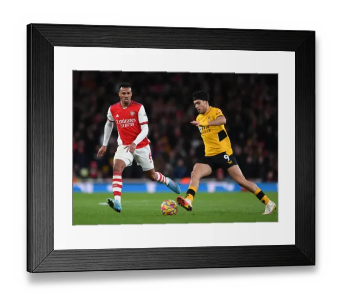 Framed Print : Gabriel Magalhaes vs. Raul Jimenez: Intense Battle in Arsenal vs. Wolverhampton Wanderers Clash
