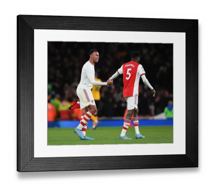 Framed Print : Arsenal: Gabriel Magalhaes and Thomas Partey Share a Moment after Arsenal vs. Wolverhampton Wanderers (2021-22) Framed Print : Arsenal: Gabriel Magalhaes and Thomas Partey Share a Moment after Arsenal vs. Wolverhampton Wanderers (2021-22)