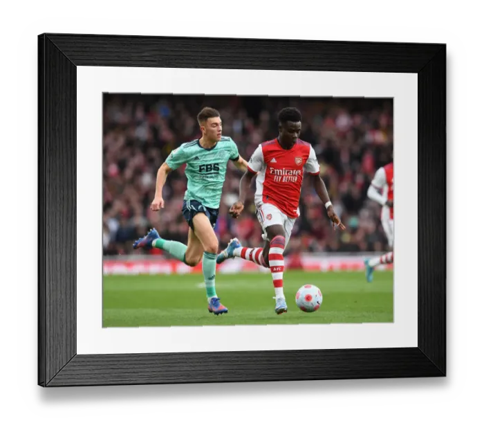 Framed Print : Saka vs. Thomas: Intense Head-to-Head Battle in Arsenal vs. Leicester Premier League Clash