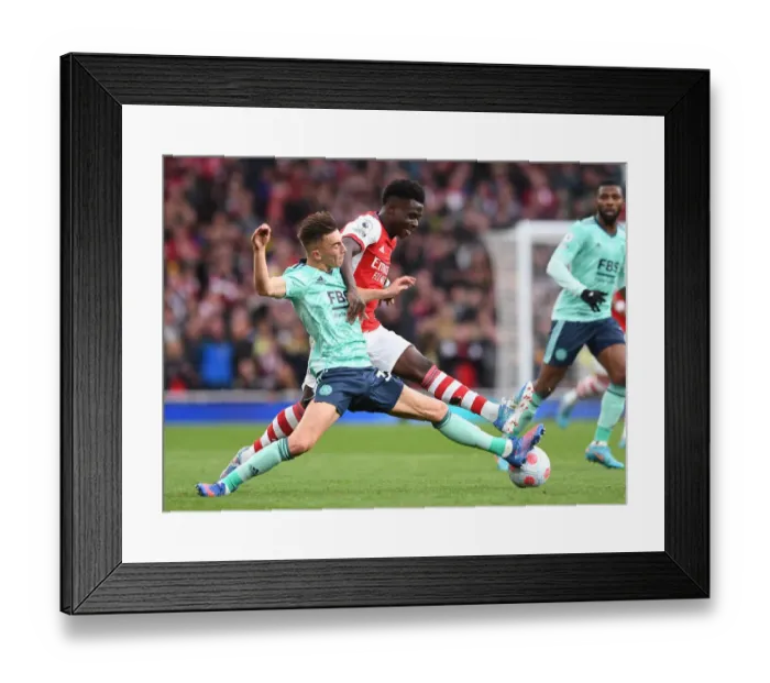 Framed Print : Arsenal's Bukayo Saka Faces Off Against Leicester City's Luke Thomas in Premier League Clash Framed Print : Arsenal's Bukayo Saka Faces Off Against Leicester City's Luke Thomas in Premier League Clash