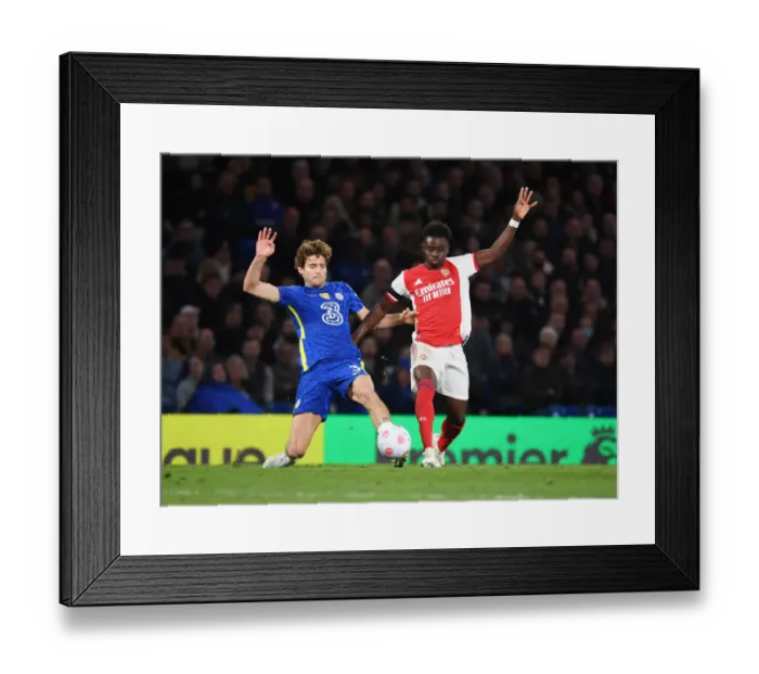 Framed Print : Saka Surges Past Alonso: Intense Battle Between Chelsea and Arsenal in the Premier League