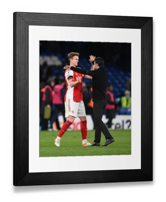Framed Print : Arsenal's Glory: Mikel Arteta and Rob Holding Celebrate Hard-Fought Premier League Victory over Chelsea