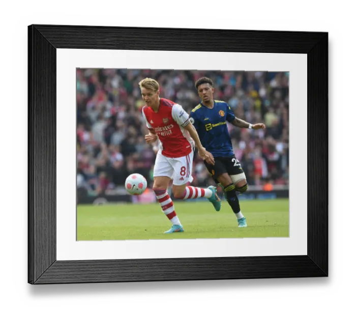 Framed Print : Clash of Talents: Arsenal's Odegaard vs. Man Utd's Sancho in the Premier League Showdown