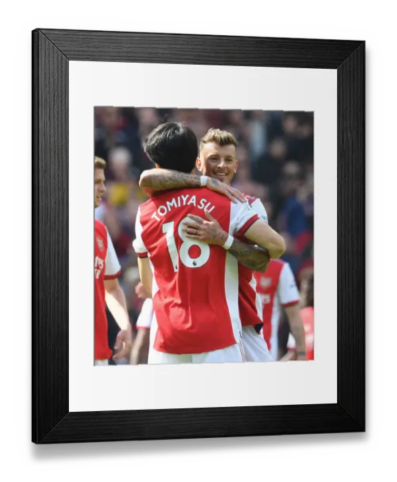 Framed Print : Arsenal's White and Tomiyasu Celebrate Victory Over Manchester United in Premier League