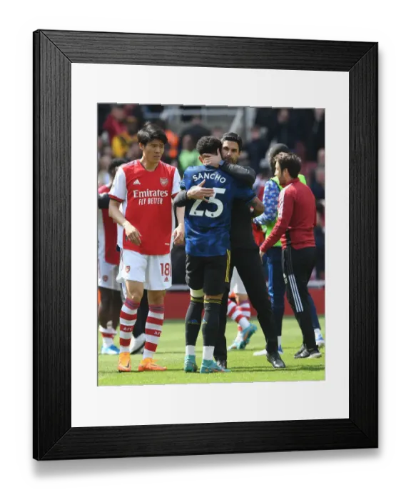 Framed Print : Arsenal's Mikel Arteta Embraces Jadon Sancho in Intense Arsenal v Manchester United Clash (2021-22) Framed Print : Arsenal's Mikel Arteta Embraces Jadon Sancho in Intense Arsenal v Manchester United Clash (2021-22)