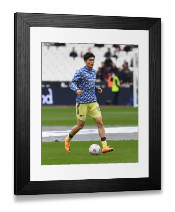 Framed Print : Arsenal's Tomiyasu Warms Up Ahead of West Ham Clash in Premier League