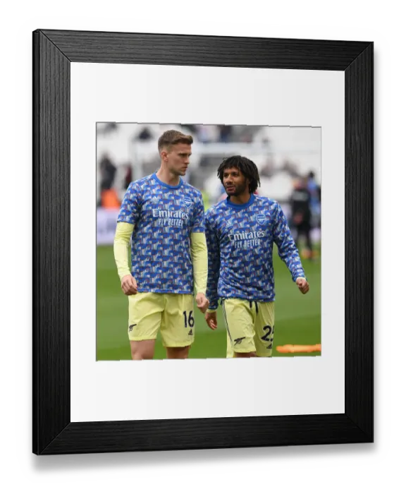 Framed Print : Arsenal Players Mohamed Elneny and Rob Holding Warm Up Ahead of West Ham United Clash (Premier League 2021-22)