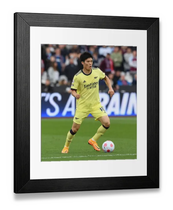 Framed Print : Arsenal's Tomiyasu in Action against West Ham United - Premier League Showdown, London 2022