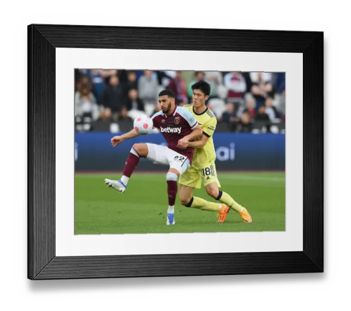 Framed Print : Clash at London Stadium: Arsenal's Tomiyasu Faces Off Against West Ham's Benrahma Framed Print : Clash at London Stadium: Arsenal's Tomiyasu Faces Off Against West Ham's Benrahma