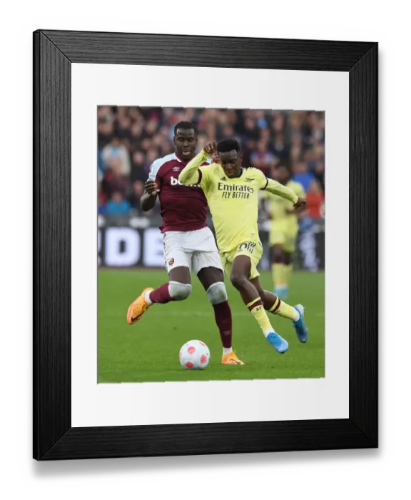 Framed Print : Arsenal's Eddie Nketiah Faces Off Against West Ham's Kurt Zouma in Premier League Clash
