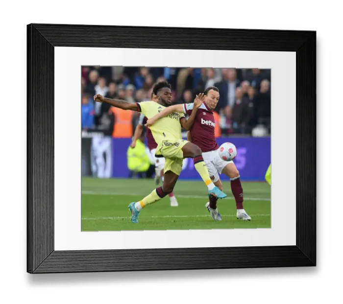 Framed Print : Nuno Tavares vs Mark Noble: Intense Clash in West Ham United vs Arsenal Premier League Match