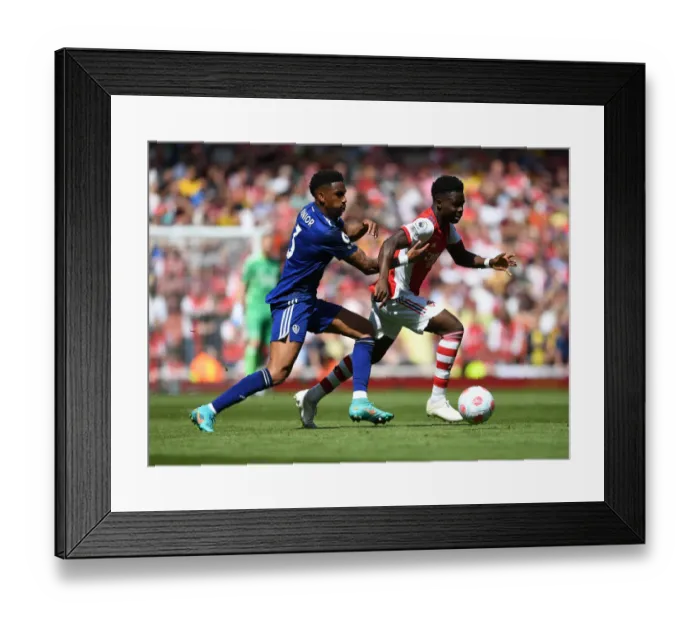 Framed Print : Arsenal's Bukayo Saka Outwits Junior Firpo in Premier League's Thrilling Showdown Framed Print : Arsenal's Bukayo Saka Outwits Junior Firpo in Premier League's Thrilling Showdown