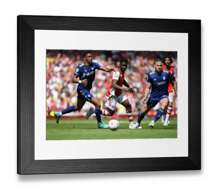 Framed Print : Arsenal's Bukayo Saka Outmaneuvers Leeds Junior Firpo in Premier League Clash Framed Print : Arsenal's Bukayo Saka Outmaneuvers Leeds Junior Firpo in Premier League Clash