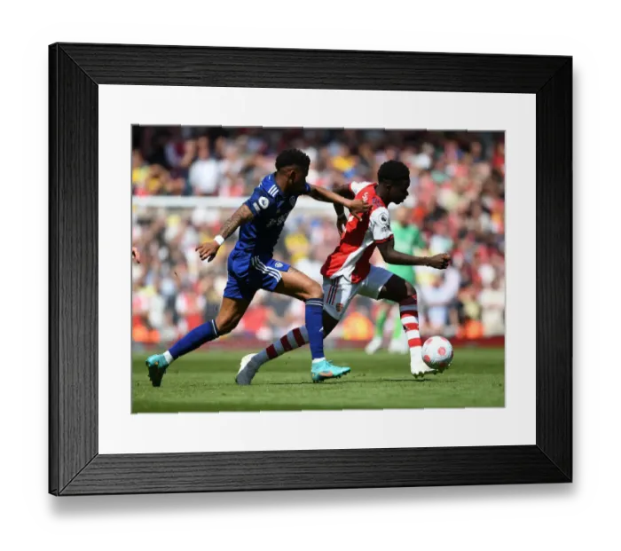 Framed Print : Saka's Skill Shines: Arsenal's Star Outmaneuvers Firpo in Premier League Clash