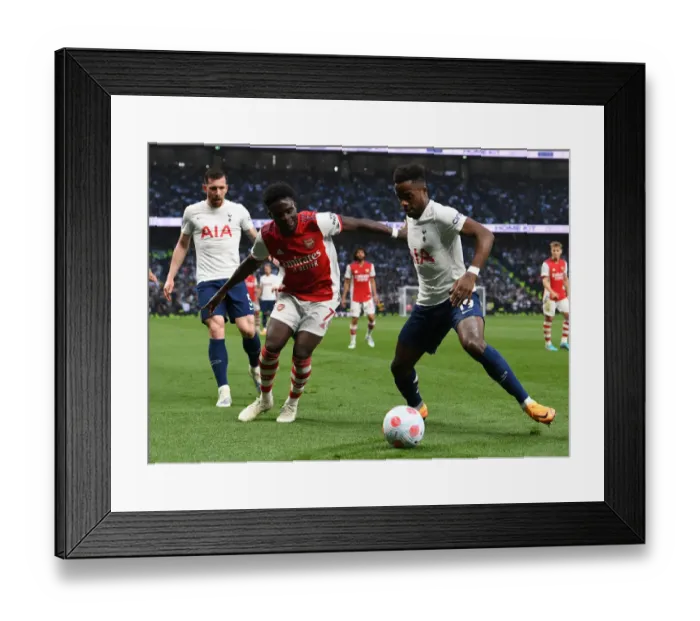 Framed Print : Bukayo Saka Closes In: Intense Battle Between Tottenham's Sessegnon and Arsenal's Saka in Premier League Showdown