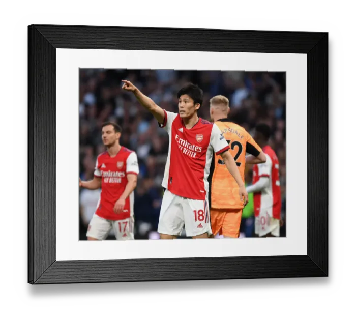 Framed Print : Tomiyasu Stands Firm: Arsenal's Defensive Hero in Intense Tottenham Showdown Framed Print : Tomiyasu Stands Firm: Arsenal's Defensive Hero in Intense Tottenham Showdown