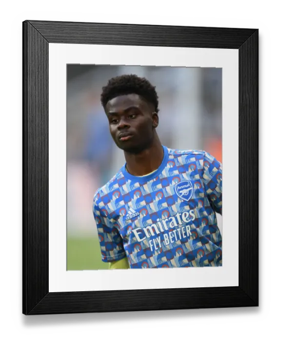 Framed Print : Arsenal's Bukayo Saka Warming Up Ahead of Newcastle United Clash in Premier League