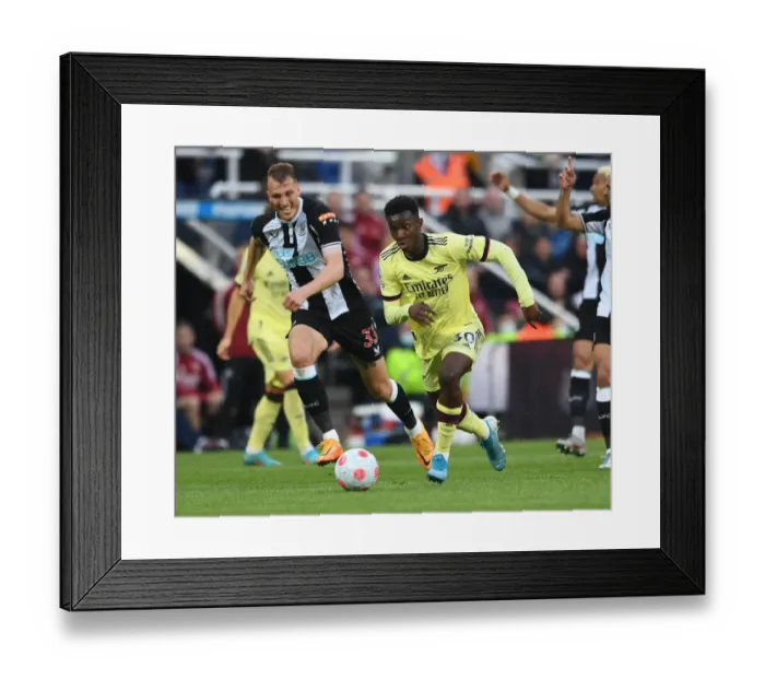 Framed Print : Arsenal's Eddie Nketiah Faces Off Against Newcastle's Dan Burn in Premier League Clash