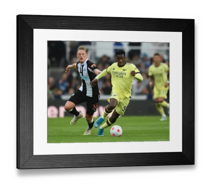 Framed Print : Arsenal's Eddie Nketiah Clashes with Newcastle's Sean Longstaff in Premier League Showdown