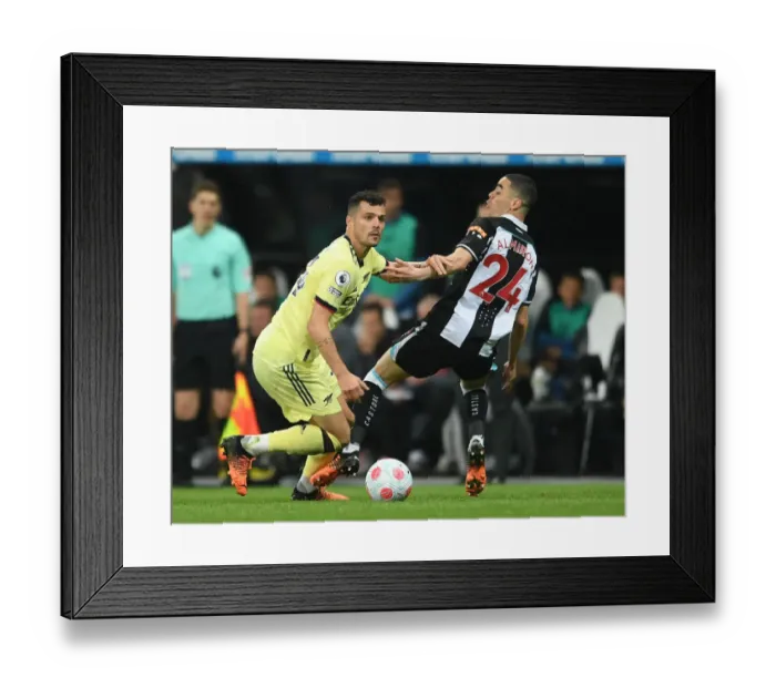 Framed Print : Xhaka vs Almiron: Intense Battle in Newcastle United vs Arsenal Premier League Clash