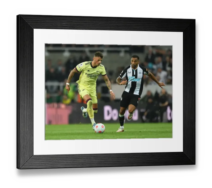 Framed Print : Arsenal's Ben White Faces Off Against Newcastle's Callum Wilson in Premier League Clash