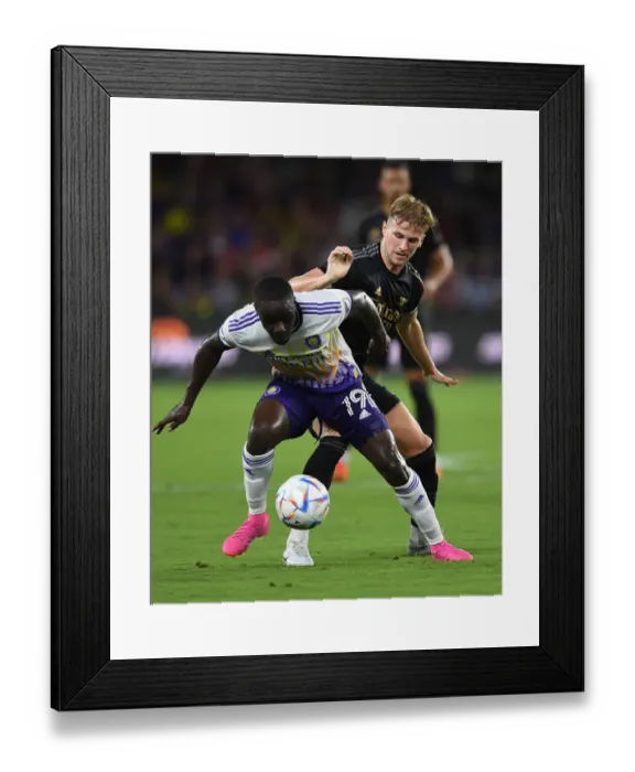 Framed Print : Arsenal vs Orlando City SC: Rob Holding Clashes with Benji Michel in Pre-Season Friendly