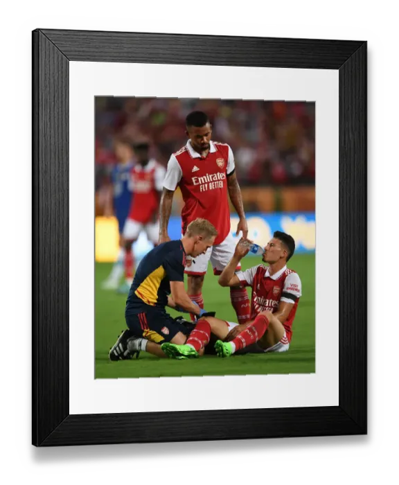 Framed Print : Arsenal: Gabriel Martinelli Receives Treatment as Arsenal Face Chelsea in Florida Cup Framed Print : Arsenal: Gabriel Martinelli Receives Treatment as Arsenal Face Chelsea in Florida Cup