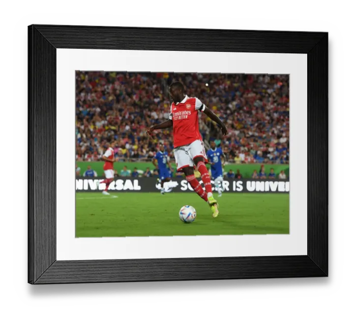 Framed Print : Arsenal's Nicolas Pepe Goes Head-to-Head Against Chelsea in the 2022-23 Florida Cup Pre-Season Clash