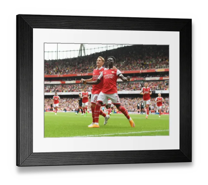 Framed Print : Arsenal's Bukayo Saka and Martin Odegaard Celebrate First Goal in Arsenal v Sevilla Emirates Cup 2022