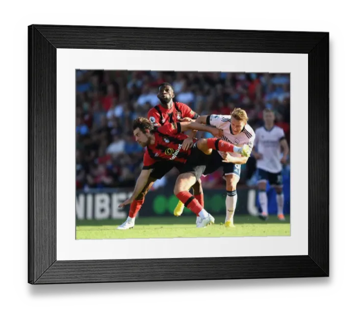 Framed Print : Odegaard Stands Firm: Arsenal's Midfield Battle against Bournemouth's Pearson and Lerma