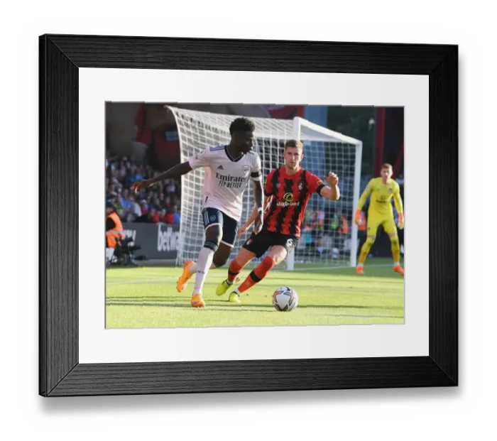 Framed Print : Saka vs. Mepham: A Premier League Showdown at Vitality Stadium Framed Print : Saka vs. Mepham: A Premier League Showdown at Vitality Stadium