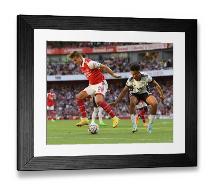 Framed Print : Arsenal's Odegaard Faces Off Against Fulham's Robinson in Premier League Clash